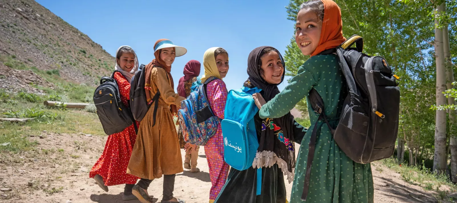 Girls with backpacks smiling together